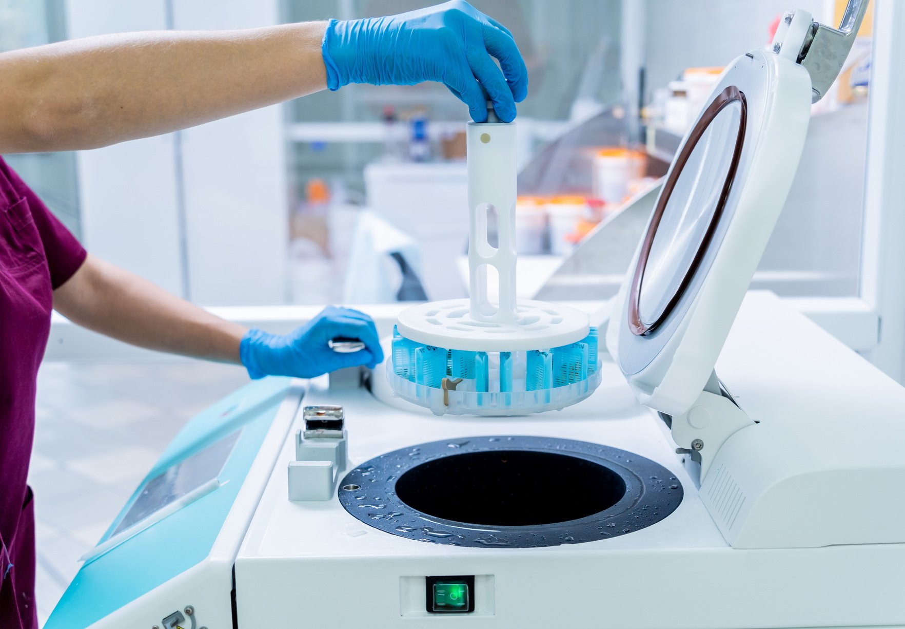 Laboratory assistant works with microwave hybrid tissue processor at the modern laboratory.